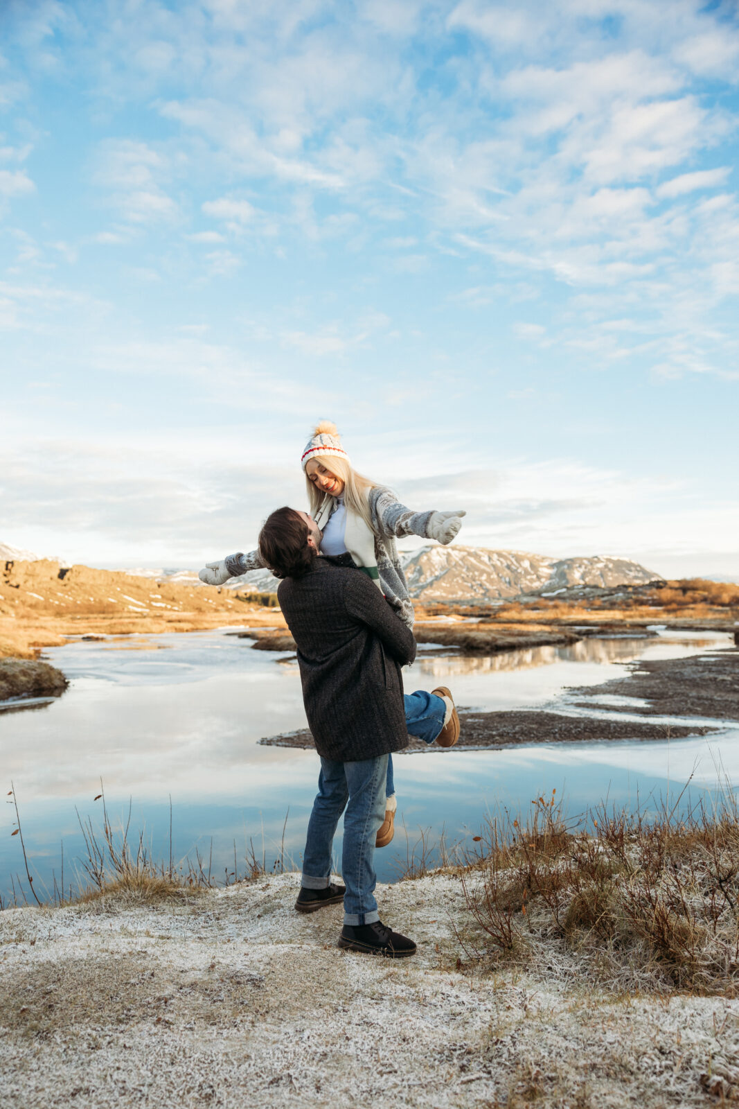 Aaron lifting Jess during a winter couples session in Iceland