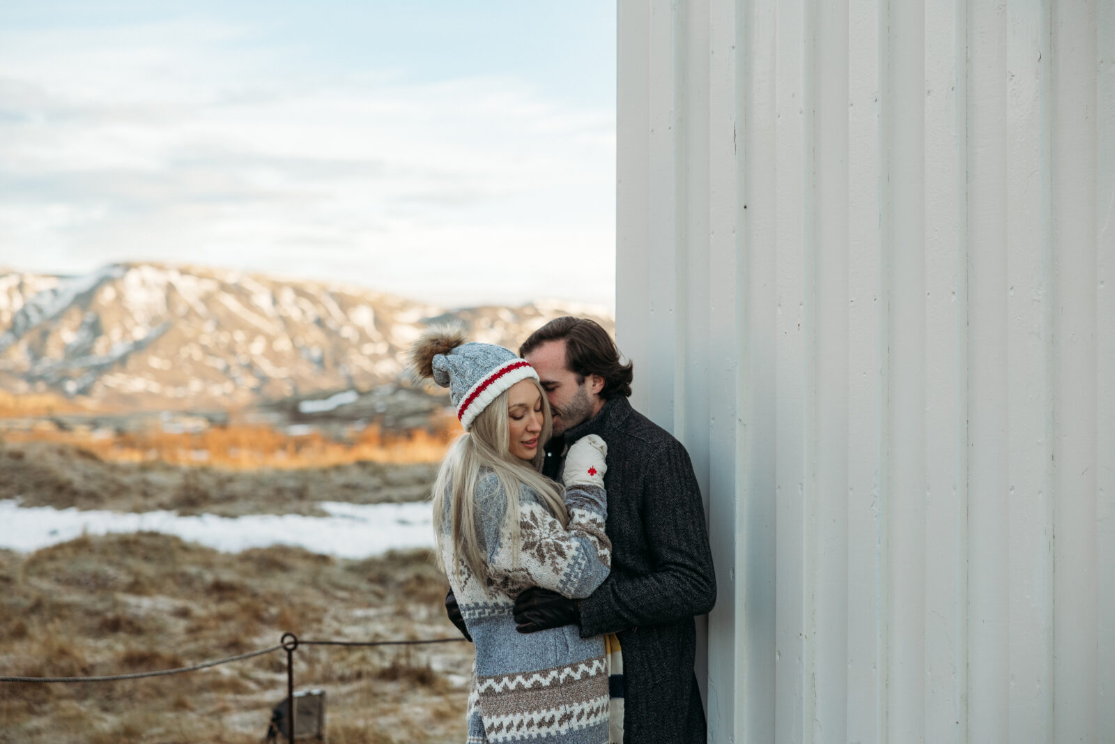 Jess and Aaron hugging during a cozy winter couples session in Iceland