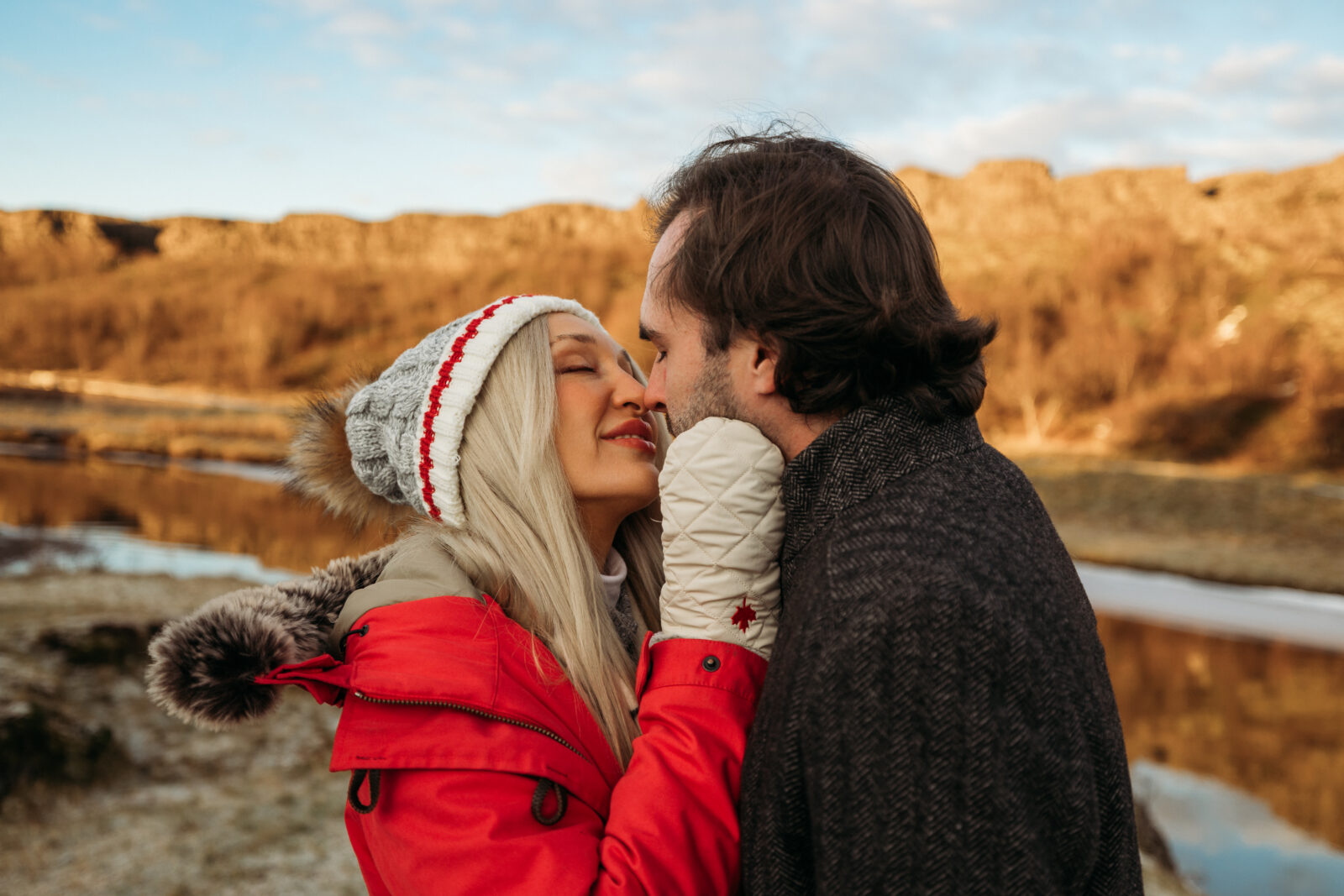 Jess and Aaron sharing a kiss during their Iceland couples session in golden hour light